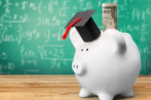 Piggy bank with grad cap and savings