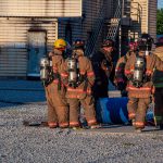 A group of firefighters preparing for a fire training exercise.