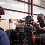 Aircraft Maintenance students working on engine.