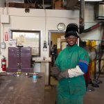 Student smiling in welding class.