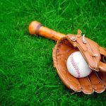 baseball bat, glove and ball in grass