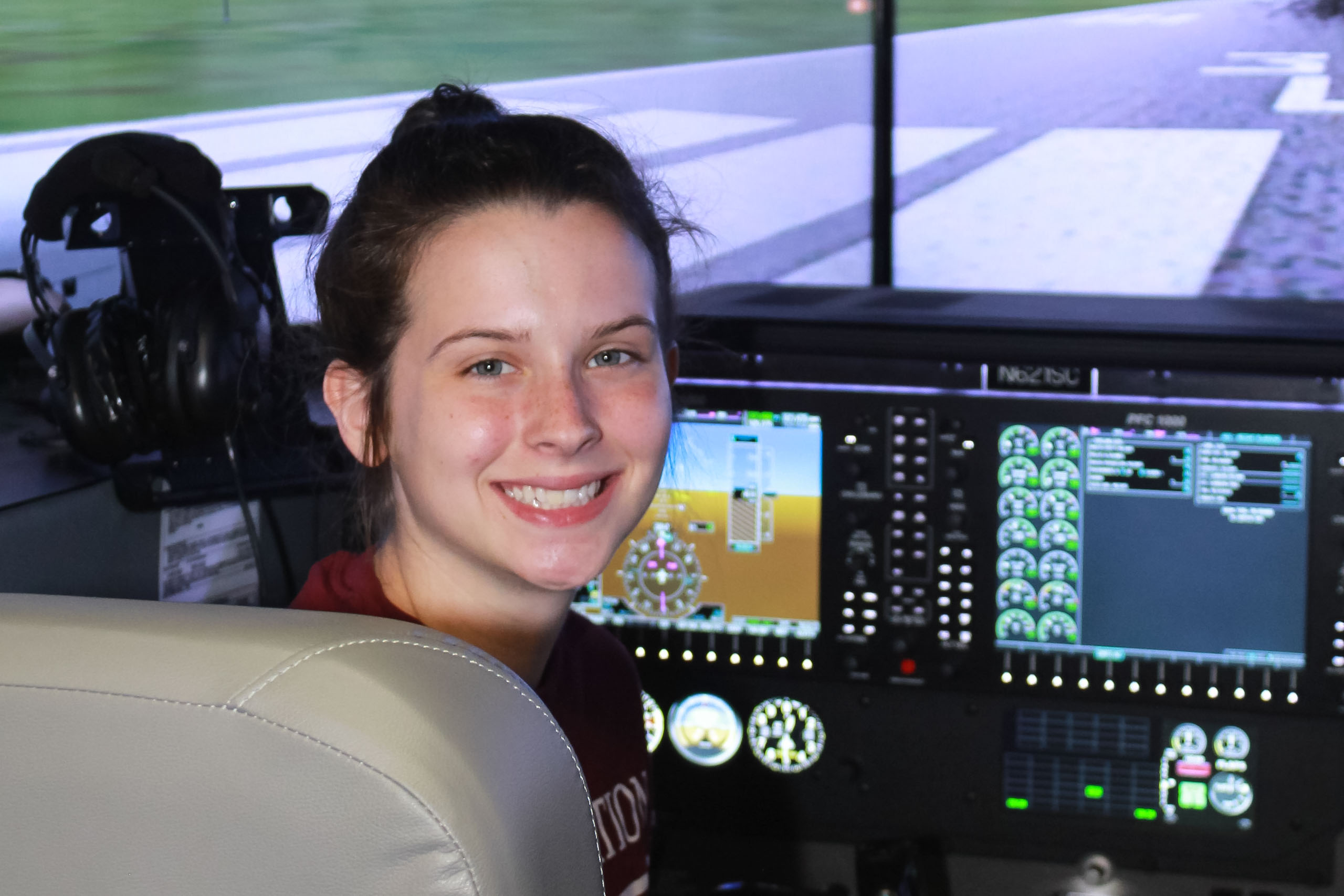 Aviation student sitting in Flight simulator Belleville Campus