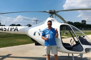 Aviation student posing with helicopter