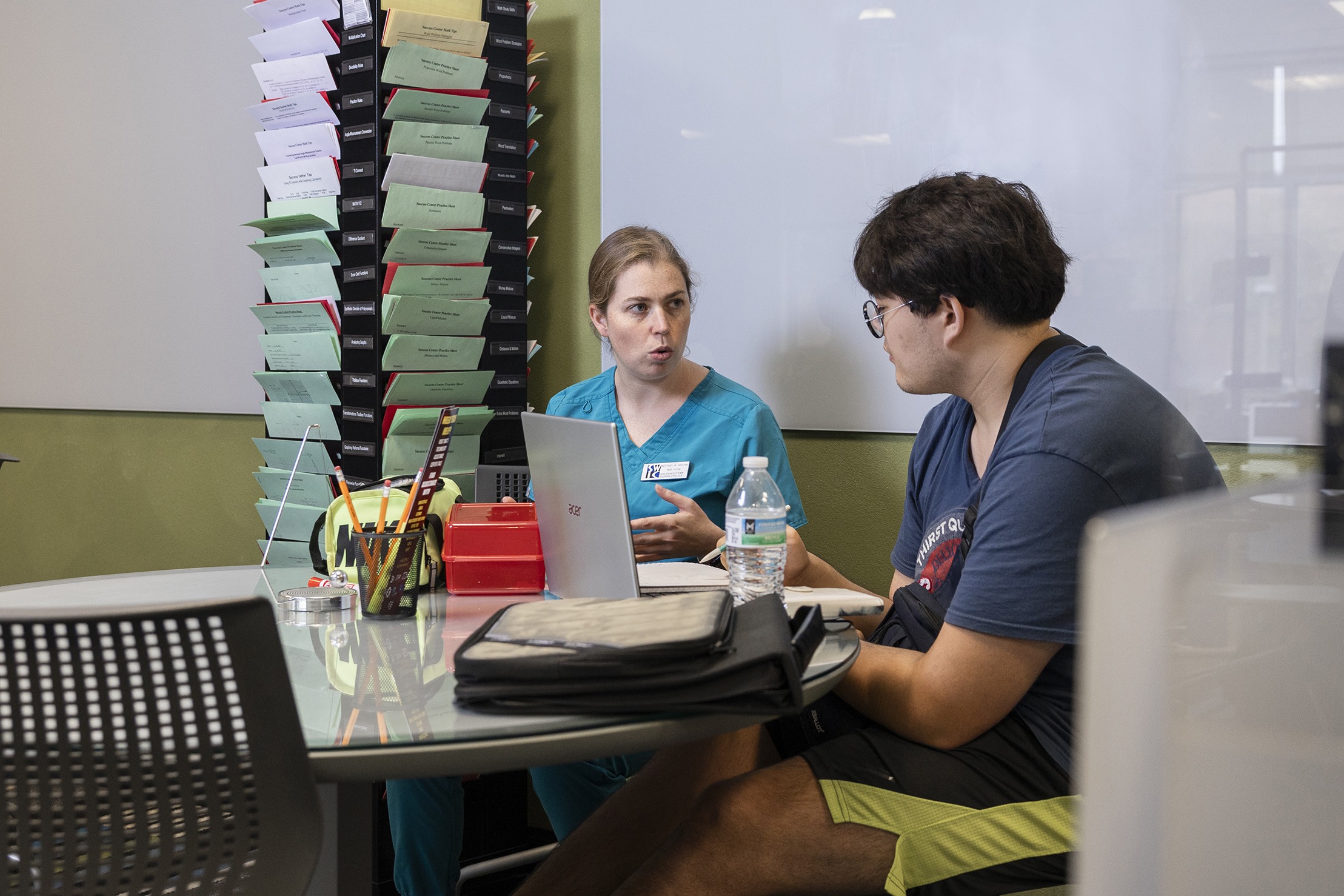 student and instructor at a computer